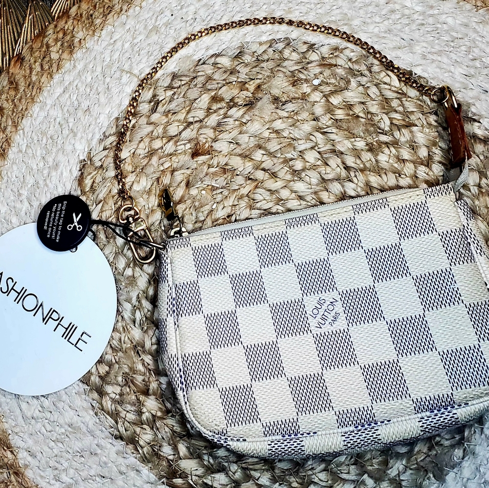 This is an authentic LOUIS VUITTON Damier Azur Mini Pochette Acces